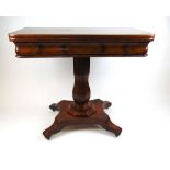 A early 19th century mahogany tea table, the fold over top supported on a swivel action on a