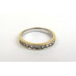 A 9ct white gold and diamond half eternity ring, the fifteen channel set stones totaling