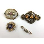 A group of four Victorian and later yellow metal brooches to include amethyst and seed pearl