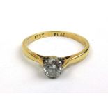 A yellow metal and diamond solitaire ring marked '18ct plat'. The round cut stone approximately 0.