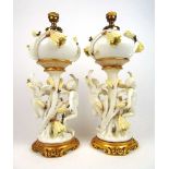 A pair of Moore Bros. oil lamps with cupid columns on gilt bases, h. 48 cmLater converted to