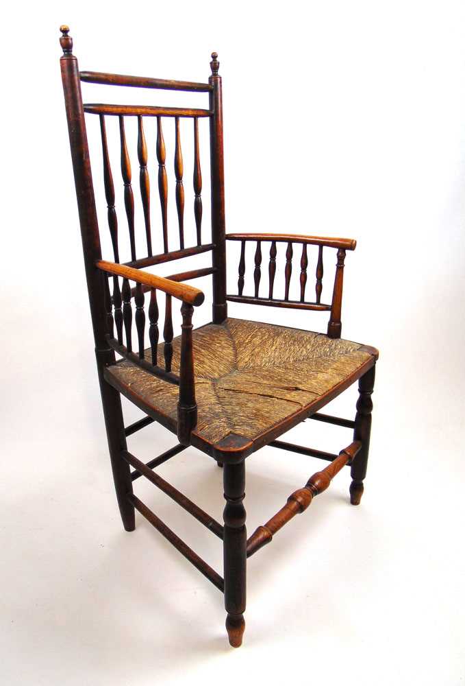 An early 19th century ash arm chair, the spindle back and arms over a rush seat on turned legs and - Bild 2 aus 7