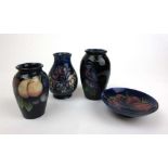 Three small Moorcroft vases to include Wisteria pattern together with a Moorcroft Anemone pattern