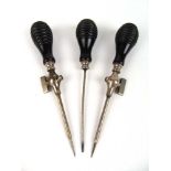 A set of three 19th century medical (possibly trepanning) instruments in associated mahogany