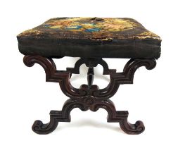 An early Victorian mahogany X-framed stool upholstered in a floral needlework fabric, h. 40 cm, w.