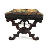 An early Victorian mahogany X-framed stool upholstered in a floral needlework fabric, h. 40 cm, w.