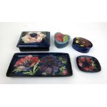 Three Moorcroft trinket boxes together with two Moorcroft pin traysLarger box restored to corner.