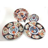 Two early 20th century Japanese imari chargers of typical design together with two smaller of