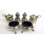 An assortment of Victorian and later silver condiment items to include salts, pepper pots and