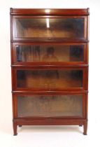 A early 20th century walnut Globe-Wernicke four section bookcase with top and base sections, h.