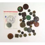 An assortment of coinage to include various Roman coins, coin weights, tokens and a contemporary