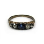 An early 20th century yellow metal, sapphire and old cut diamond ring, the central sapphire