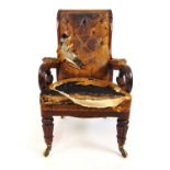 A William IV mahogany library chair, the carved top rail over the carved and pierced arms on