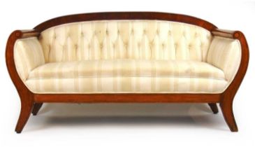 A 19th century American cherry and ebony strung settee upholstered in a button back striped white