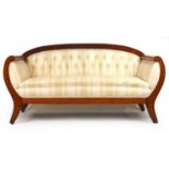 A 19th century American cherry and ebony strung settee upholstered in a button back striped white