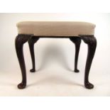 An early 20th century, 18th century style walnut stool upholstered in a white gold fabric, the