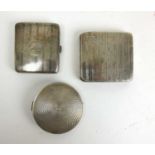 Two silver engine turned cigarette cases together with a silver compact. Various hallmarks. Approx