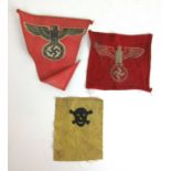 A Third Reich swastika and eagle pennant together with one similar patch and one skull and