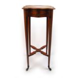 An early 20th century satinwood and painted kettle stand, the serpentine top with painted