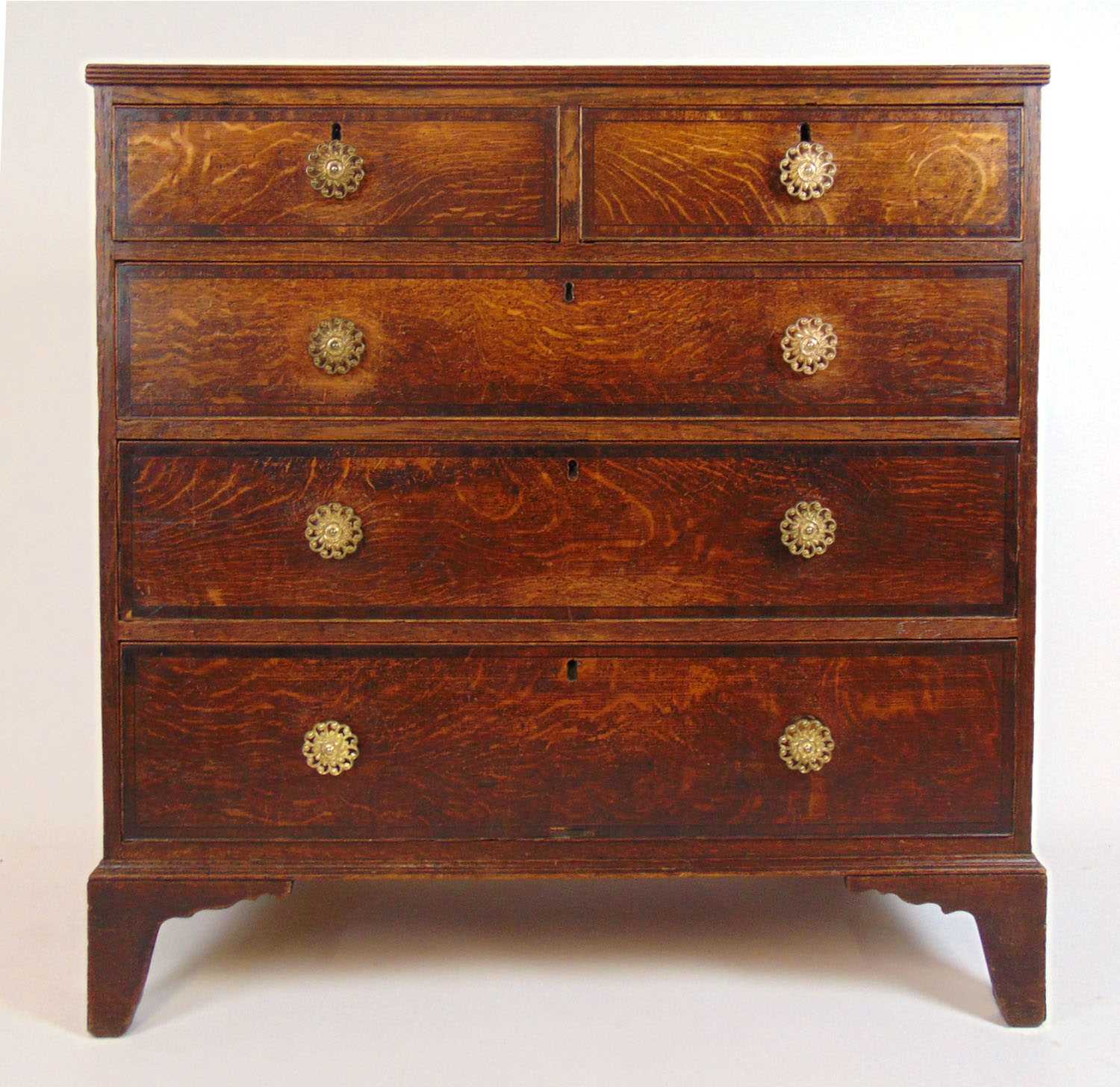 An 18th centruy oak and mahogany banded chest of two short over three long drawers on bracket