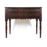 An early 20th century oak side table, the moulded top over four carved drawers on turned legs, h. 75