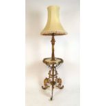 An early 20th century gilt brass and onyx standard lamp converted form an oil lamp, the column
