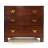 An early 19th century mahogany chest of three long drawers on bracket feet, h. 84 cm, w. 93 cm, d.