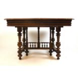 A 19th century French oak extending dining table, the top with one extra leaf over the base with
