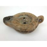 A Roman terracotta oil lamp with accompanying certificate, l. 14.5 cmSome damage