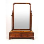 An early 18th century burr walnut toilet mirror, the moulded frame over the base with two trinket