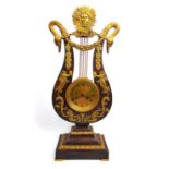 A late 19th century French mahogany and brass mounted lyre clock, the sun flanked by swan heads over