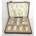 A cased set of six Minton china coffee cups and saucers decorated in a bird and floral design,