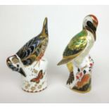 A Royal Crown Derby paperweight in the form of a Great Spotted Woodpecker together with one in the