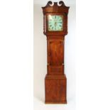An early 19th century oak and mahogany long case clock, the swan neck pediment over the enameled