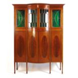 An Edwardian mahogany boxwood strung and tulipwood banded bow front side cabinet, The cornice over