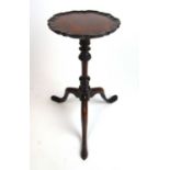 An early 20th century, 18th century style mahogany tripod table, the shaped top on the turned column