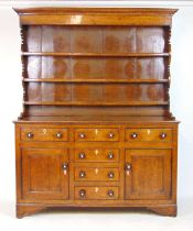 An 18th century oak dresser, the plate rack over the base with three drawers over two cupboard doors