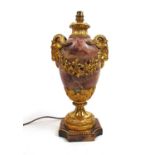 An early 20t century veined purple marble and gilt brass mounted table lamp, the urn body with