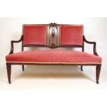 An Edwardian mahogany, boxwood strung and satinwood banded settee upholstered in a cut pink