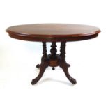 An Edwardian burr walnut and marquetry breakfast table, the oval quarter veneered top on the five