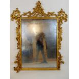 A 19th century French giltwood mirror, the frame surmounted by fleur-de-lis over foliate scrolls,