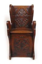 A Victorian carved oak coal box/seat, the carved back over the seat and fall front, h. 91 cm, w.