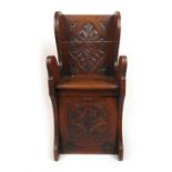 A Victorian carved oak coal box/seat, the carved back over the seat and fall front, h. 91 cm, w.