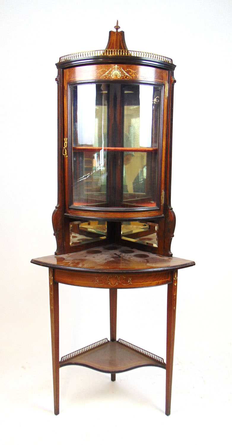 An Edwardian rosewood, boxwood strung and marquetry floorstanding corner display cabinet, the