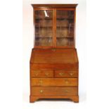 An 18th century and later oak bureau bookcase, the cornice over two astragal glazed doors above