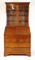An 18th century and later oak bureau bookcase, the cornice over two astragal glazed doors above