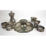 A collection of silver items to include an inkwell, pepper mill, napkin rings etc. Various