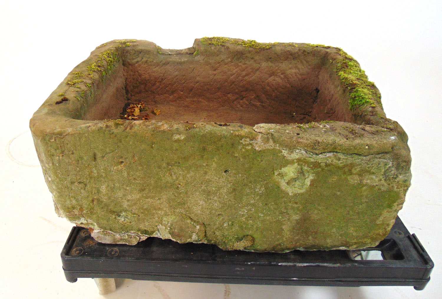 A sandstone sink, h.30 cm, w. 78 cm, d. 57 cmWeathered. Repairs to one corner. Trolly not included