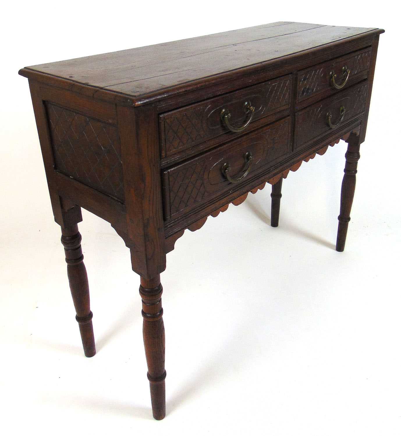 An early 20th century oak side table, the moulded top over four carved drawers on turned legs, h. 75 - Bild 2 aus 2