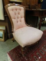 An Edwardian walnut boxwood strung and marquetry nursing chair upholstered in a floral pink